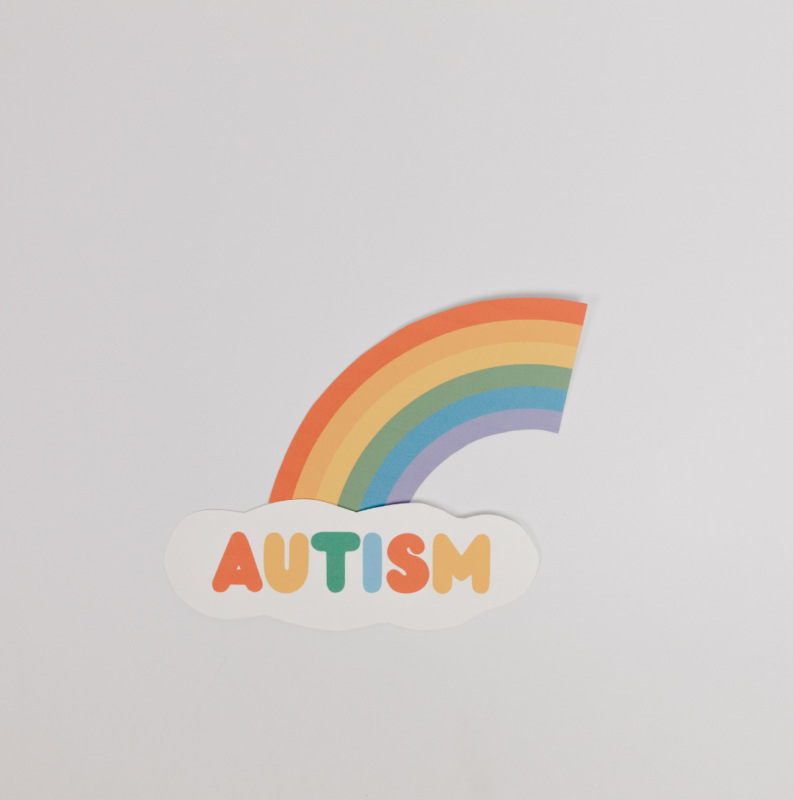There is word that says autism with a rainbow coming from the word.